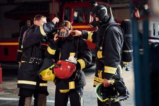 Group of firefighters in protective uniform that is on station.
