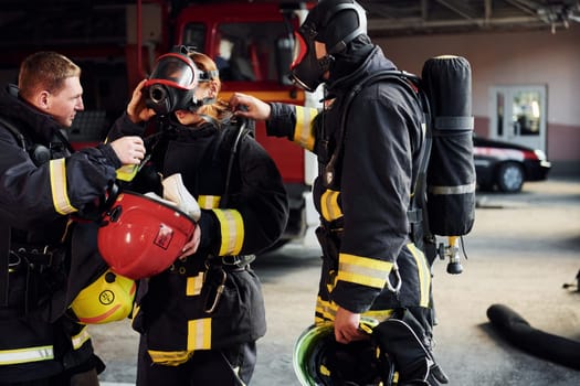 Group of firefighters in protective uniform that is on station.
