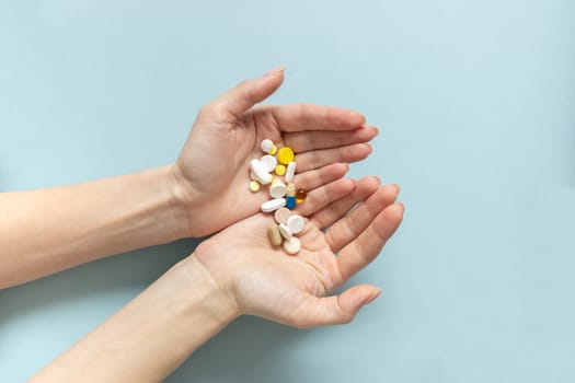 Hands of woman holding pills. Seasonal affective disorder concept.