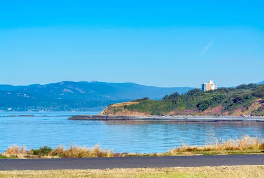 Scenery veiw of Pacific ocean bay on Vancouver island with high-rise building on the shore