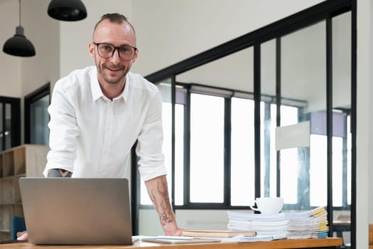 Portrait of successful business man, businessman in glasses and business suit looking at camera and smiling.