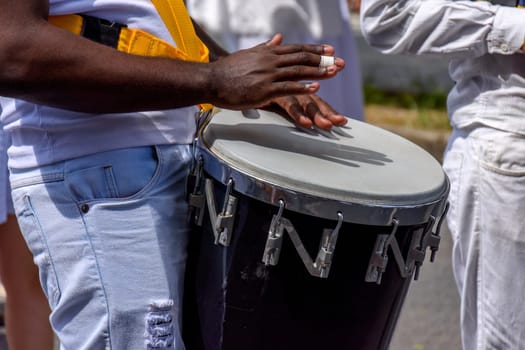 Atabaque drum player in the streets of Brazil during brazilian samba presentation