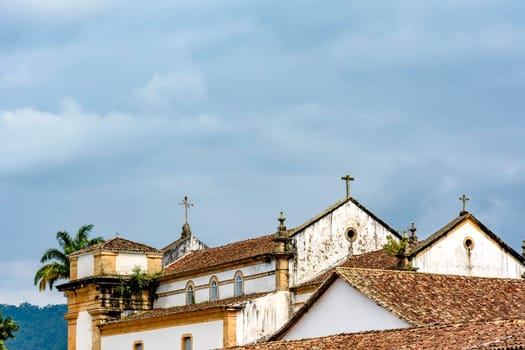 Back view of old colonial style church and roofs in the historic center of Paraty in overcast day