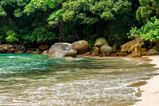 Beach in remote and deserted location in Trindade on the south coast of the state of Rio de Janeiro surrounded by rocks and the rainforest