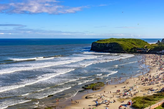 Beach on a beautiful sunny day in the summer of Torres city on the coast of Rio Grande do Sul state, Brazil