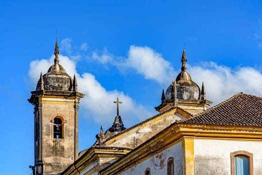 Beautiful historic church in baroque style with its towers jutting out against the blue sky in Ouro Preto, Minas Gerais