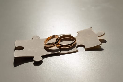 Wedding rings and puzzle pieces. Husband and wife complement each other perfectly