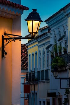 Beautiful street with historic colonial style houses and lantern in Pelourinho in Salvador, Bahia during dusk