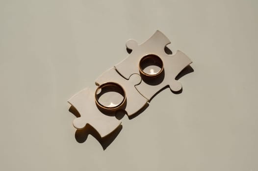 Wedding rings and puzzle pieces. Husband and wife complement each other perfectly