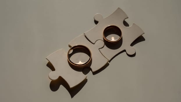 Wedding rings and puzzle pieces. Husband and wife complement each other perfectly