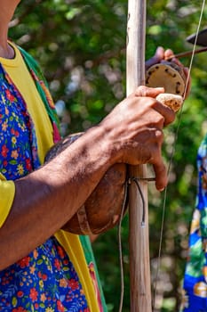 Berimbau player playing his instrument during typical folk festival in the interior of Brazil