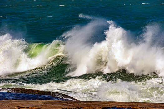 Big waves crashing on the beaches of Rio de Janeiro during a tropical storm in summer