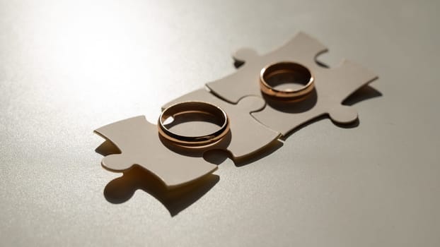 Wedding rings and puzzle pieces. Husband and wife complement each other perfectly