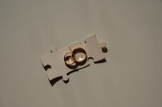 Wedding rings and puzzle pieces. Husband and wife complement each other perfectly
