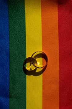 Legalization of same-sex marriages. Rainbow flag and wedding rings