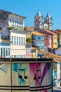 Colorful drum with the Pelourinho district with its historic and colorful houses and churches in the background in the city of Salvador, Bahia