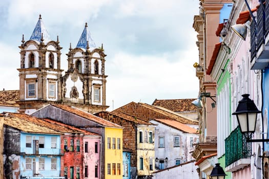 Colorful historic district of Pelourinho with cathedral tower on the background. The historic center of Salvador, Bahia, Brazil.