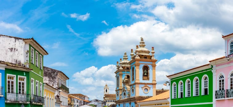 Colorful facades of houses and historic church in Pelourinho in Salvador on a sunny day