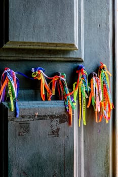 Famous colorful ribbons of good luck from Our Lord of Bonfim tied to the door of the church in Salvador, Bahia