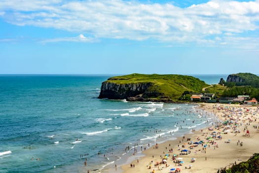 Crowded beach on a beautiful sunny day in the summer of Torres city on the coast of Rio Grande do Sul state, Brazil