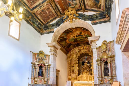 Interior and altar of a brazilian historic ancient church from the 18th century in baroque architecture with details of the walls in gold leaf in the city of Tiradentes, a UNESCO World Heritage Site, Minas Gerais State, Brazil