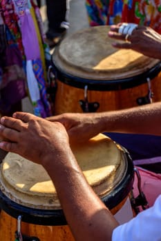 Percussionist playing atabaque during folk samba performance on the streets of Rio de Janeiro