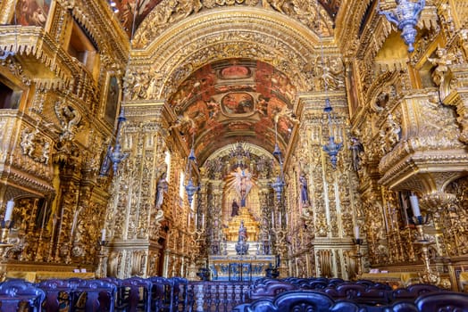 Interior and altar of a brazilian historic ancient church from the 18th century in baroque architecture with details of the walls in gold leaf in the city of Rio de Janeiro, Brazil