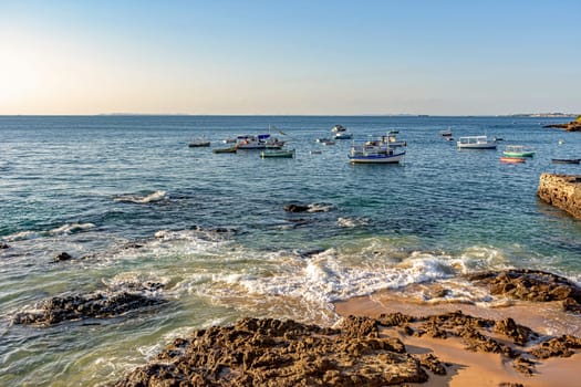 Fishing and leisure boats in the sea of All Saints Bay in Salvador, Bahia during the late afternoon