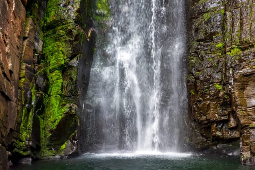 Gorgeous and paradisiacal waterfall of Veu da Noiva (Veil of the Bride) among the mossy rocks and vegetation located in Serra do Cipo in the state of Minas Gerais, Brazil and