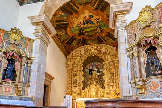 Interior and altar of a brazilian historic ancient church from the 18th century in baroque architecture with details of the walls in gold leaf in the city of Tiradentes, a UNESCO World Heritage Site, Minas Gerais State, Brazil