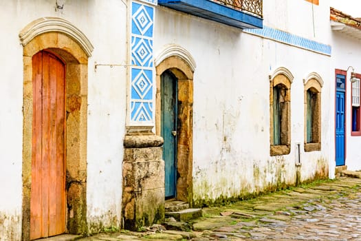 House facade in weather-damaged colonial architecture on cobblestone street in the historic city of Paraty in the state of Rio de Janeiro, Brazil