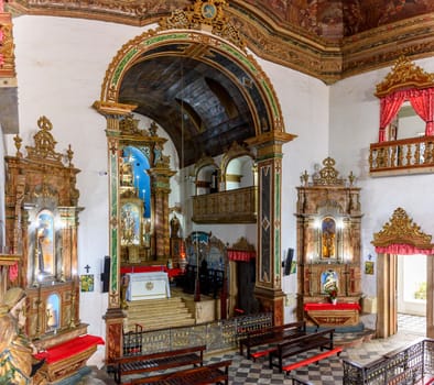 Interior of a antique baroque church in Salvador, Bahia, richly decorated with gold-plated walls and altar