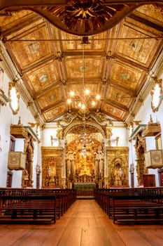 Interior and altar of a brazilian historic ancient church from the 18th century in baroque architecture with details of the walls in gold leaf in the city of Tiradentes, a UNESCO World Heritage Site, Minas Gerais State, Brazil