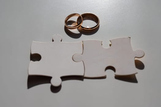 Wedding rings and puzzle pieces. Husband and wife complement each other perfectly