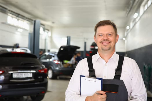 Portrait of confident male mechanic in workshop. Car service and repair concept