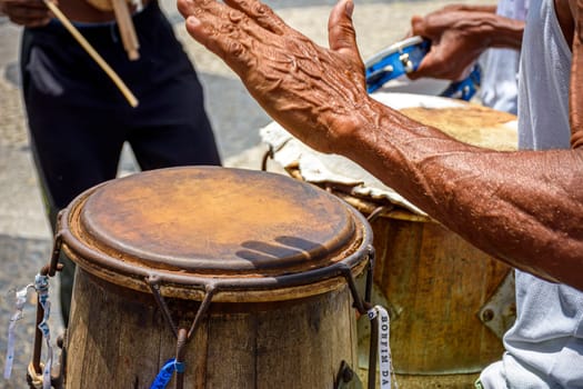 Musicians playing traditional instruments used in capoeira, a mix of fight and dance from Afro-Brazilian culture in the streets of Pelourinho in Salvador, Bahia