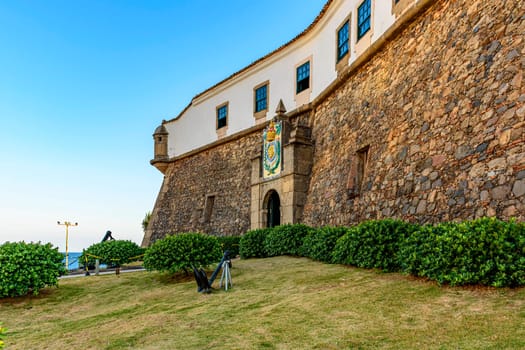 Facade of the old and historic fort and Barra lighthouse at afternoon in the city of Salvador, Bahia