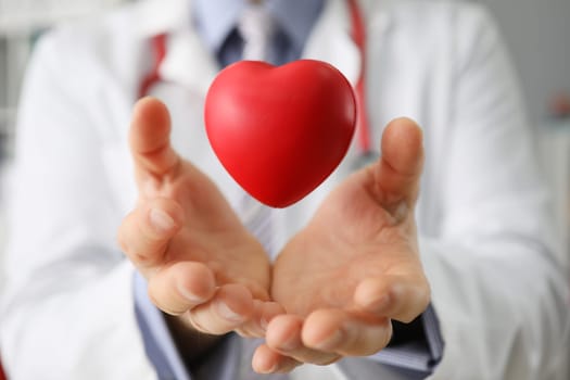Medical insurance or healthcare concept doctor holding heart. Diagnosis treatment of cardiovascular disease concept