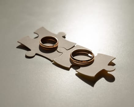 Wedding rings and puzzle pieces. Husband and wife complement each other perfectly