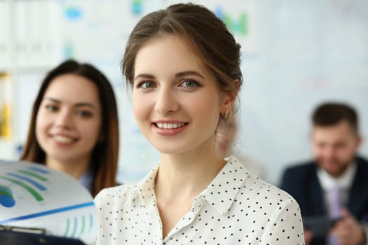 Portrait of beautiful businesswoman at presentation with team of business people. Professional training of marketers concept