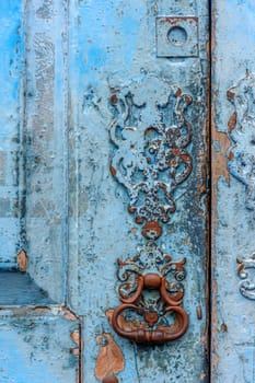 Detail of old wooden door and lock deteriorated by time and rust in a colonial style house in the historic city of Diamantina in Minas Gerais