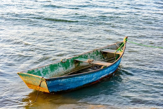 Old wooden fishing boat floating over sea