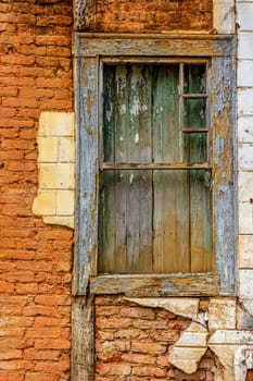 Old wooden window ruined by time on the facade of abandoned house in the historic city of Diamantina in Minas Gerais