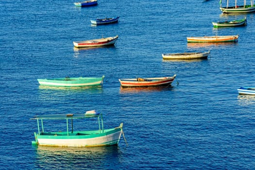 Rustic wooden fishing boats in the sea of the city of Salvador in Bahia