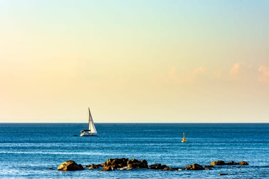 Sailing boat sailing over the calm waters of Baia de Todos os Santos in the city of Salvado in Bahia