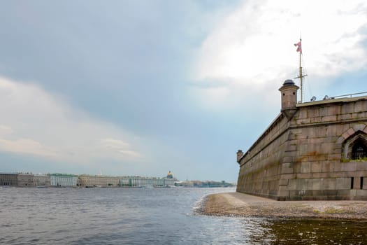 Saint Petersburg city seen from inside the old and historic Saint Peter fortress with the Neva river in the foreground