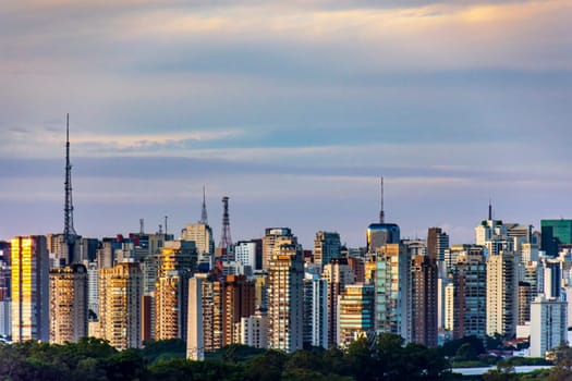 Wall of buildings, towers and communication antennas at dusk in the city of Sao Paulo, Brazil