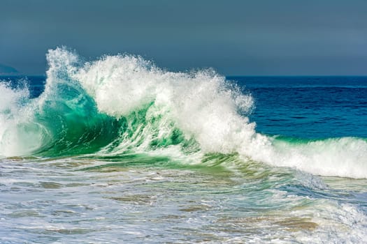 Strong beautiful wave with vivid colors breaking on Ipanema beach in Rio de Janeiro on a dangerous sea day in summer