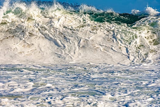 Strong wave and sea foam at Ipanema beach in Rio de Janeiro on a sunny day