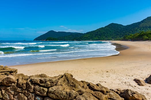 Stunning beach in Bertioga on the north coast of the state of Sao Paulo surrounded by untouched forest and mountains